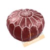 Dark red leather pouf with white arabesques