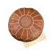 Light brown leather pouf with white arabesques