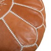 Light brown leather pouf with white arabesques