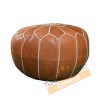 Light brown leather pouf with white arabesques