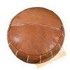 Light brown leather pouf with white arabesques