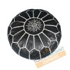 Black leather pouf with white arabesques