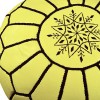 Yellow leather pouf with black arabesques